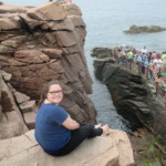 A young woman sits atop a rock face on a hike taking place during an Aspergers College Transition Program hiking trip, helping teens with ASD experience the outdoors and improve their sense of adventure and confidence