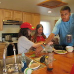 A group of teens taking place in a cooking class at Beyond Akeela, designed to help teens with autism and aspergers to build community and try new challenges that will help them prepare for college and post collegiate life.