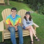 Two campers from Beyond Akeela taking a rest on a bench at the camp.